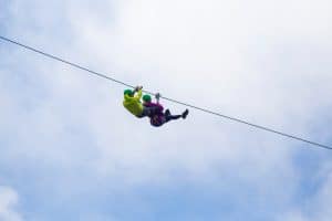 Adventurous tourist zip lining