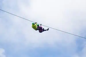 Adventurous tourist zip lining