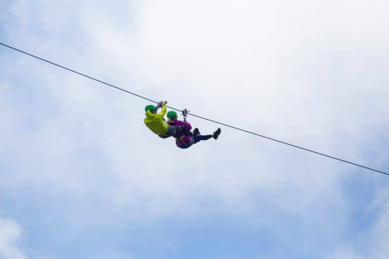 Adventurous tourist zip lining