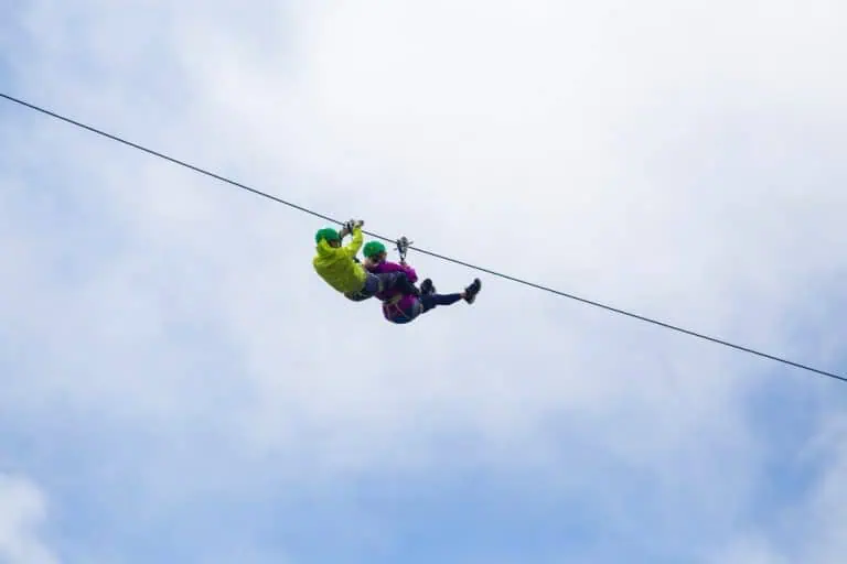 Adventurous tourist zip lining